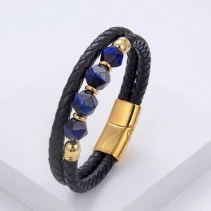 Detail of black woven leather bracelet with blue hexagonal stone beads and gold magnetic clasp