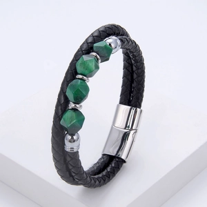 Detail of men's double-layer black braided leather bracelet with green stones and magnetic clasp