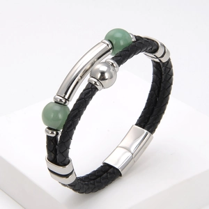 Macro detail of braided black leather bracelet with green beads and silver magnetic clasp