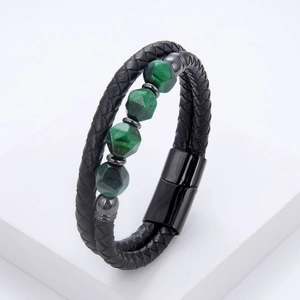 Detail of men's braided black leather bracelet with green gemstones and magnetic clasp