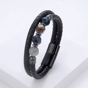 Macro view of double-layered braided leather bracelet with geometric natural stone beads
