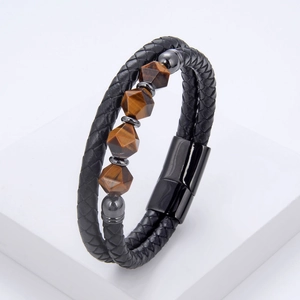 Detailed macro view of black braided leather bracelet featuring tiger eye stone beads
