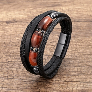 Detail of men's leather multi-layer bracelet featuring red tiger eye stones and magnetic clasp