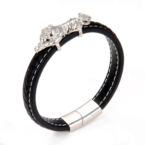 Detail of hand-woven black leather bracelet with silver tiger head and magnetic clasp