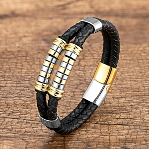 Close-up of double-layer black braided leather bracelet with silver and gold magnetic clasp