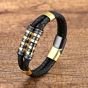 Close-up of double-layer black braided leather bracelet with gold magnetic clasp