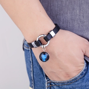 Close-up of Scorpio constellation leather bracelet with silver metal buckle on wrist