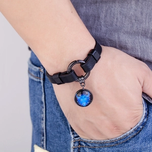 Detailed view of black leather Taurus constellation bracelet with round bull charm
