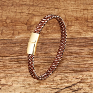 Detail of hand-woven brown leather cord bracelet with square gold magnetic clasp