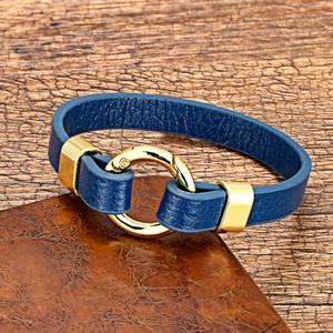 Close-up of dark blue leather bracelet with high-quality texture and gold metal buckle
