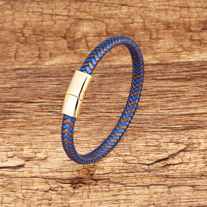 Macro detail of blue and brown woven leather bracelet with gold magnetic metal clasp