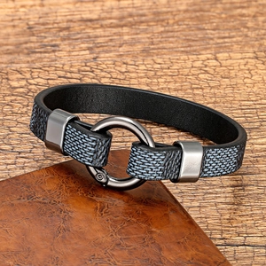 Detail of blue-grey fabric and black leather men's bracelet with dark metal clasp