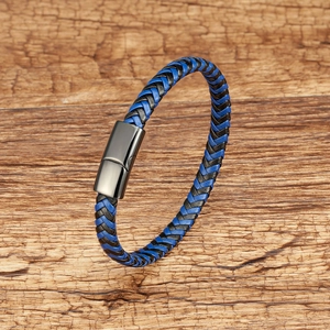 Detailed close-up of woven blue and black leather bracelet with sleek magnetic clasp