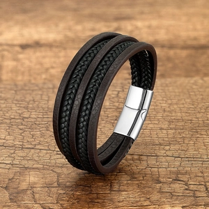 Close-up of black and brown multi-layer braided leather bracelet with stainless magnetic clasp