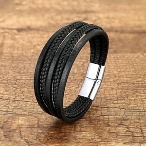 Close-up of multi-layer black braided leather bracelet with polished silver magnetic clasp
