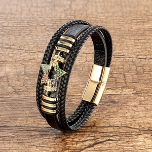 Close-up of multi-layer leather bracelet with gold star charm and magnetic clasp
