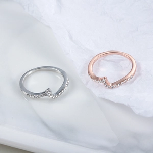 Elegant wave-shaped zircon rings in silver and rose gold with micro-paved crystals