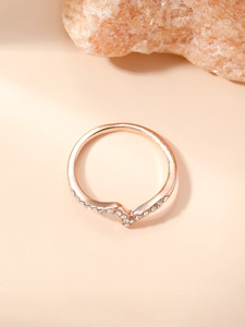 Detail shot of a rose gold V-shaped wave ring featuring elegant white zircon stones