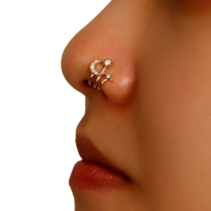 U-shaped non-pierced gold nose cuff featuring zircon-studded star and moon charms