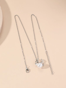 Detailed view of silver reindeer pearl necklace with zircon-embellished antlers