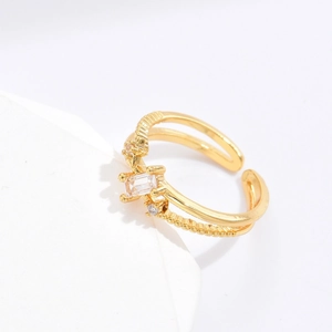 Detail view of double-layered gold ring with rectangular zircon and beaded texture