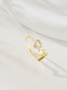 Detail of MOM design golden ring featuring a hollow heart set with white zircon stones