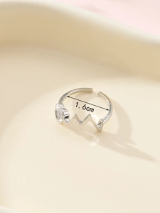 Detail view of silver heart wave ring with 1.6cm inner diameter measurement guide