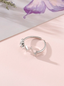 Macro shot of silver heartbeat wave ring featuring heart shape with sparkling crystals