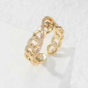 Adjustable golden Cuban link ring with a micro-paved zircon wavy line on a white stand