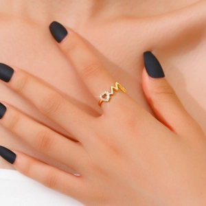 Detail of gold wave ring featuring a heart and letter M design with sparkling zircon stones