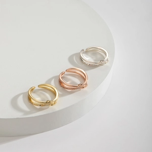 Detailed view of adjustable knot rings in gold, rose gold and silver with cubic zirconia