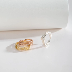 Three-color minimalist knot rings in gold, rose gold and silver with zircon accents