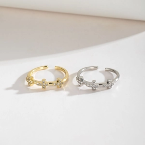 Minimalist adjustable cross rings set in gold and silver with cubic zirconia stones