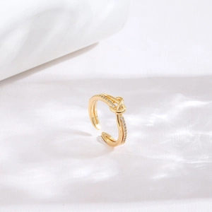 Minimalist gold heart knot ring with sparkling zircon insets and adjustable open band