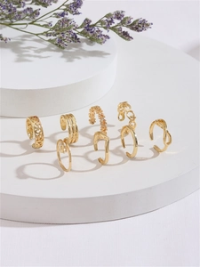 Detailed set of seven golden adjustable toe rings in heart, floral, and geometric designs