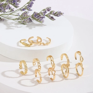 Set of 12 vintage gold-plated rings with heart and star patterns in open design
