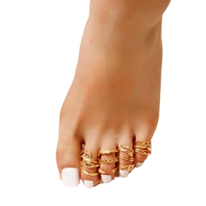 12-piece vintage gold toe ring set with heart and star designs on white background