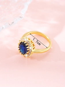 Detail shot of golden sapphire ring showing 1.7cm inner diameter size measurement