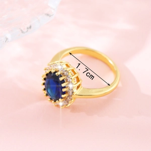 Princess cut gold ring with large oval blue sapphire and white zircon halo, 1.7cm diameter