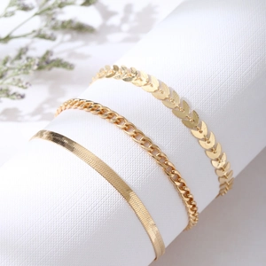 Ensemble de trois bracelets de cheville en acier doré avec mailles épi, gourmette et serpent