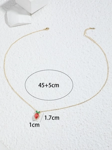 Detail view of gold strawberry pendant with red zircon and size markings 45+5cm