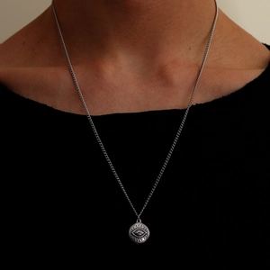 Minimalist stainless steel evil eye sun pendant necklace for women on a model