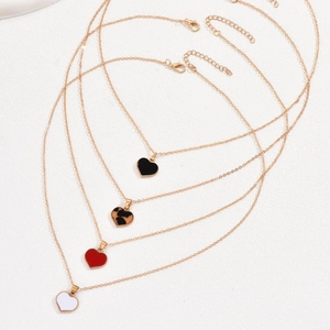 Layered gold necklaces with heart pendants in black, leopard, red and white colors