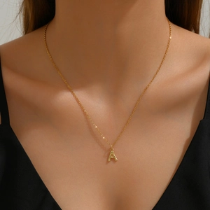 Minimalist gold necklace featuring a bamboo style letter A pendant on delicate chain