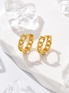 Detailed view of bamboo-joint gold-plated geometric hoop earrings on a stone display