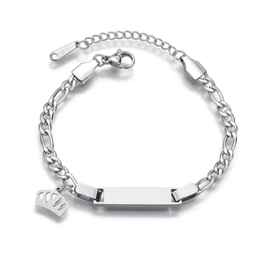 Detailed view of silver Figaro chain bracelet with blank rectangular bar and crown charm