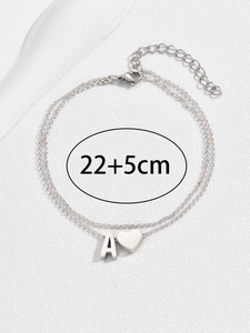 Close-up of double layer heart anklet with letter A pendant and lobster clasp detail