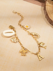 Detailweergave van de gouden oceaanarmband met schildpad-, dolfijn- en schelphangers