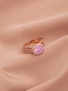 Detailed macro of a rose gold triple-layered ring with a large pink zircon center stone