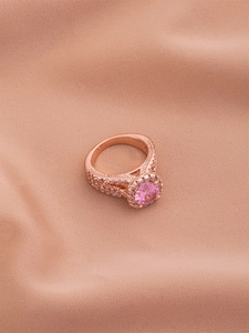 Close-up of rose gold plated ring with round pink zircon and pave white crystal details